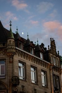 A historic building displays the night sky.